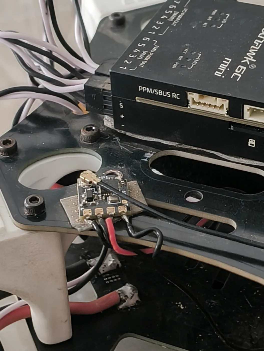 Close-up of the drone flight controller and its wiring on the frame