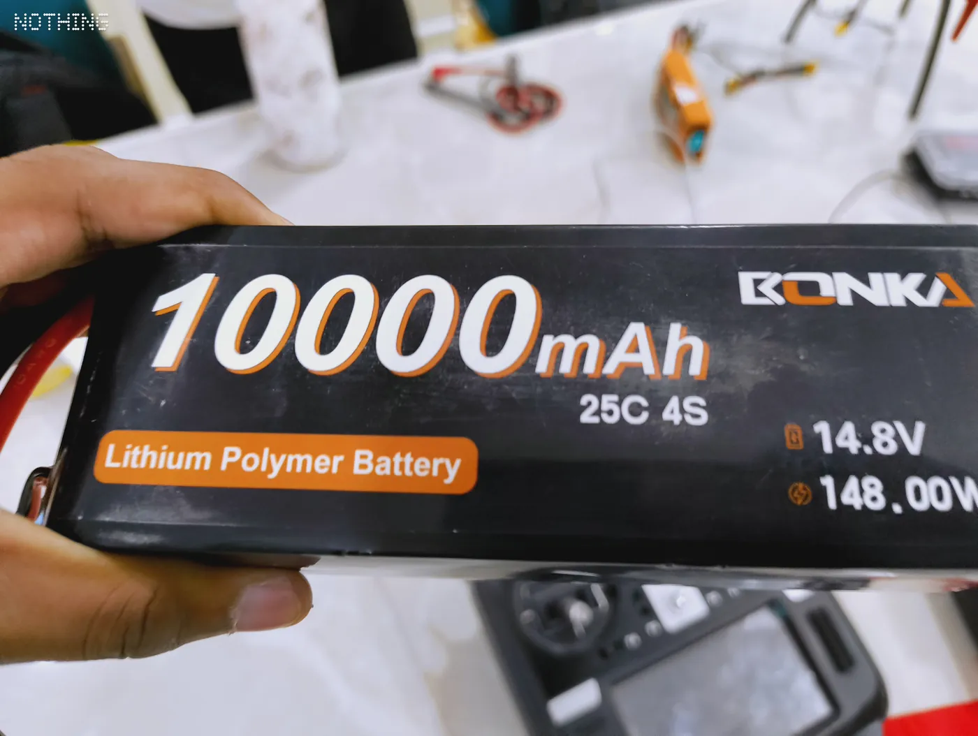 10000 mAh 4S lithium-polymer drone battery held in hand
