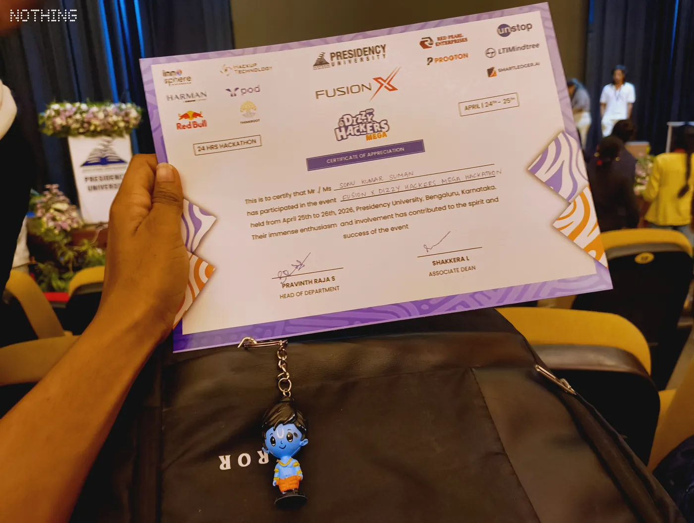 Participation certificate held up at a hackathon venue