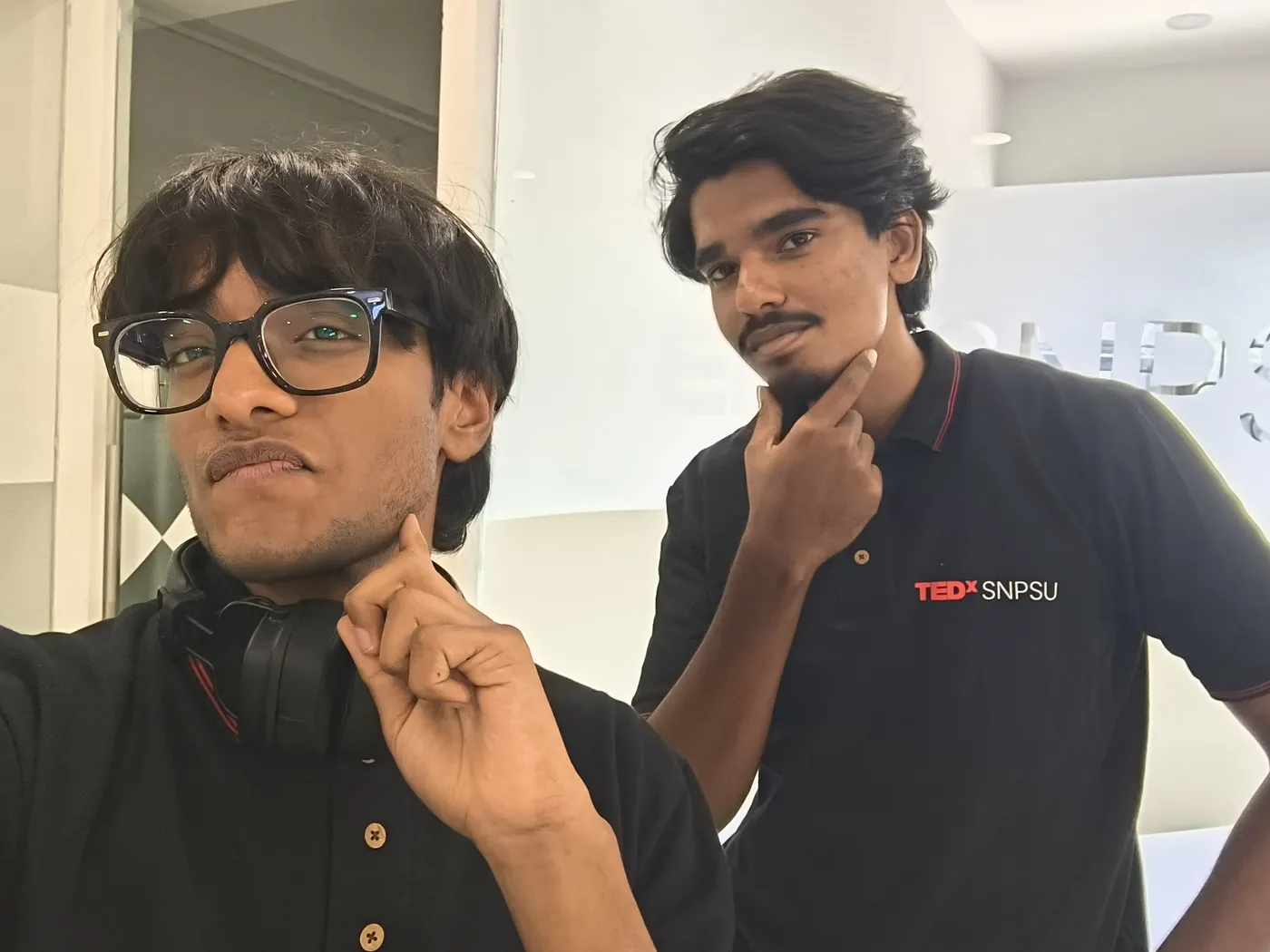 Sonu Kumar Suman and a fellow volunteer posing in black TEDxSNPSU polo shirts