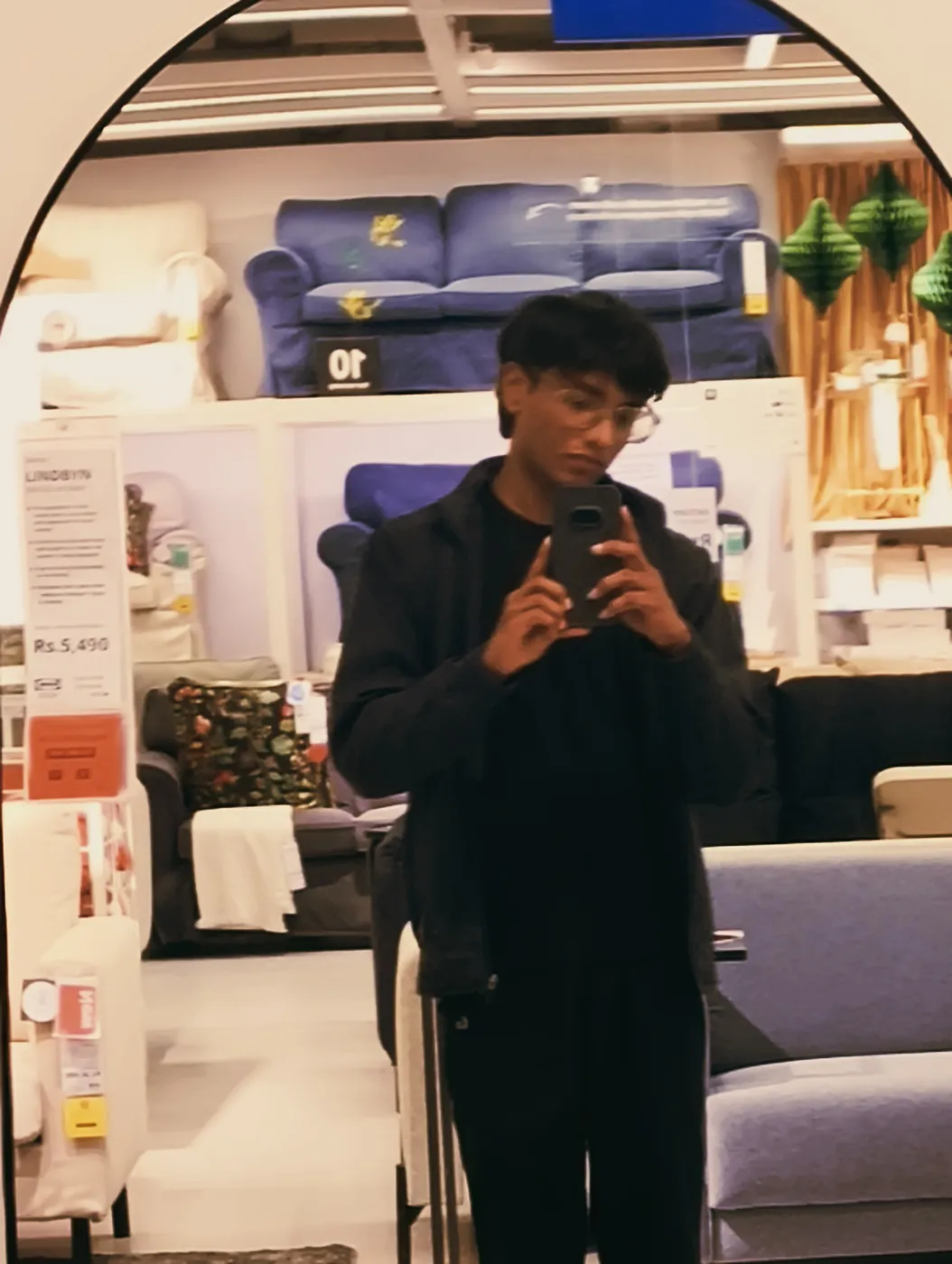 Mirror selfie of Sonu Kumar Suman in the bedding section of a home furnishing store