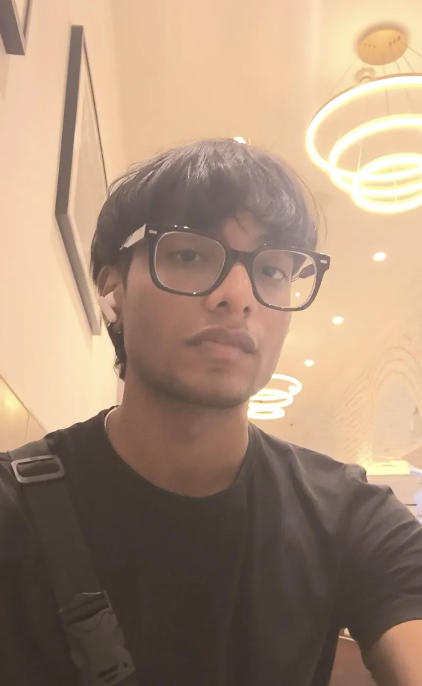 Selfie of Sonu Kumar Suman in a black T-shirt under ring-shaped ceiling lights