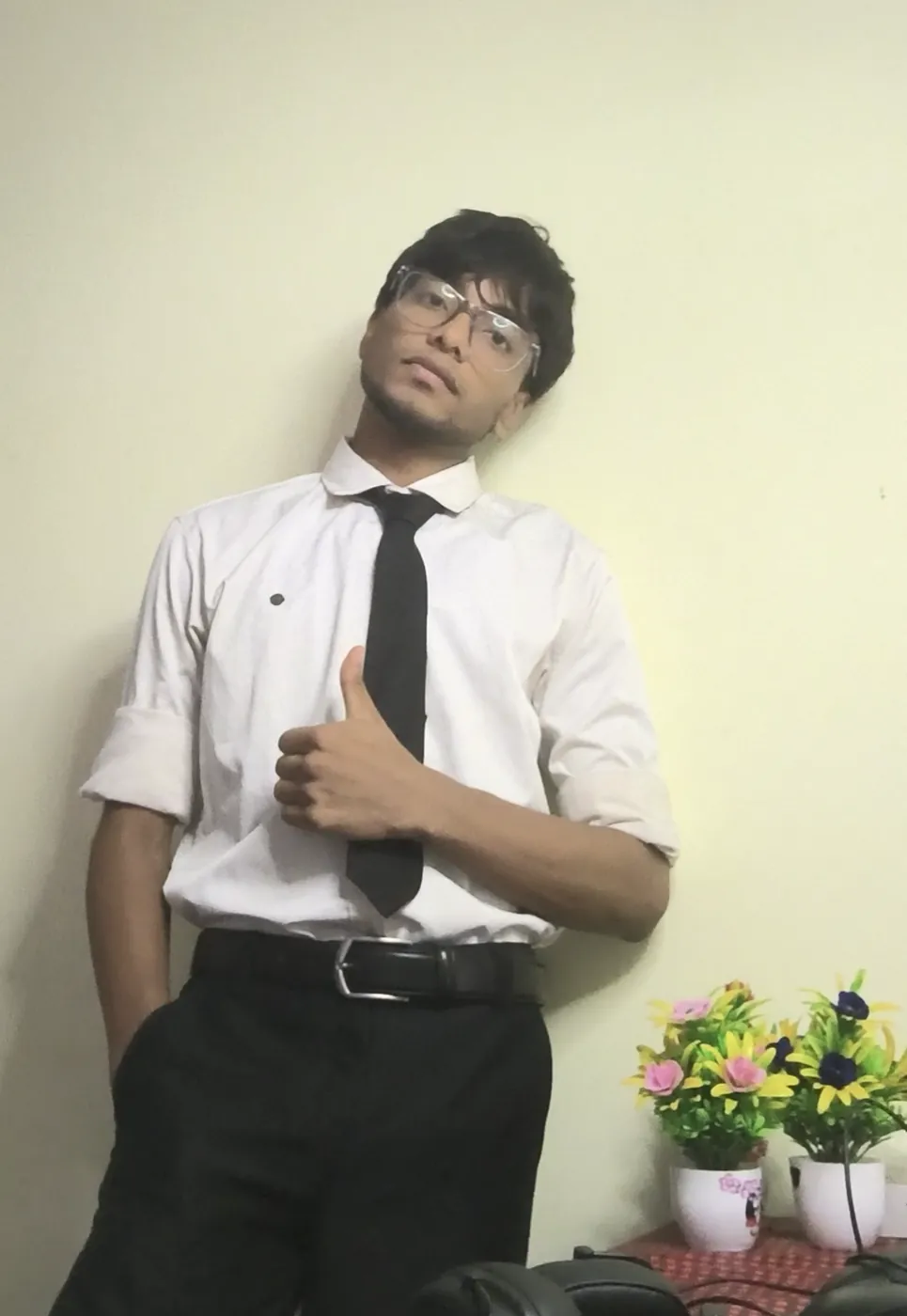 Sonu Kumar Suman in a white shirt and black tie giving a thumbs up