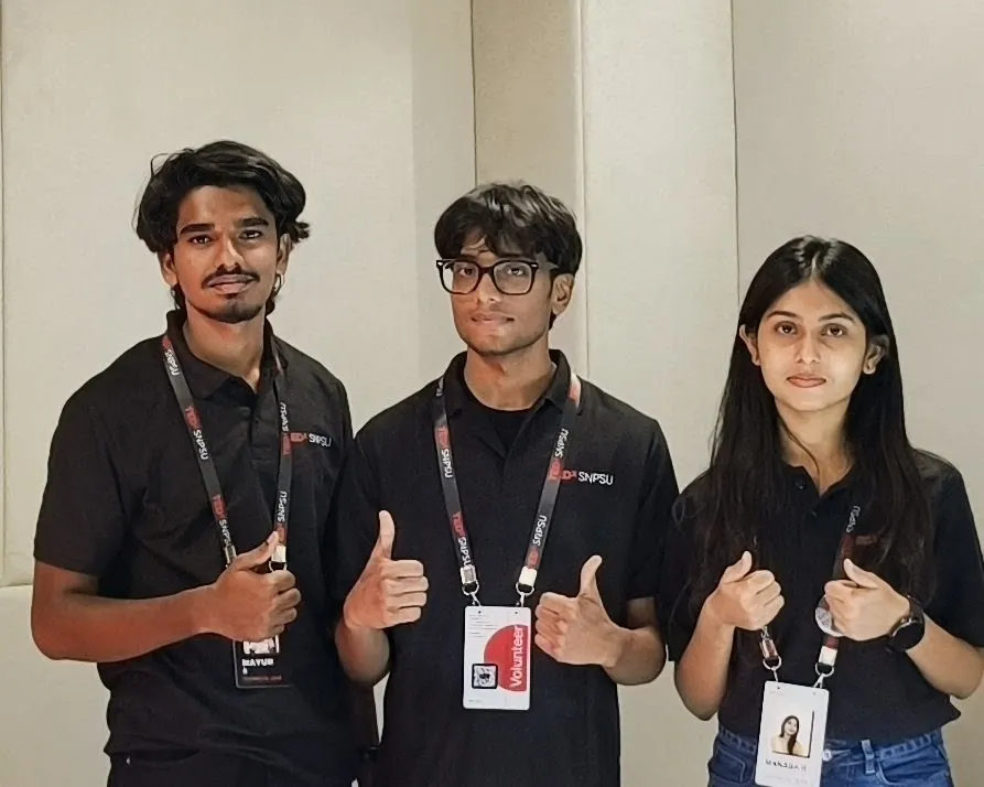 Sonu Kumar Suman with two fellow TEDxSNPSU volunteers giving a thumbs up