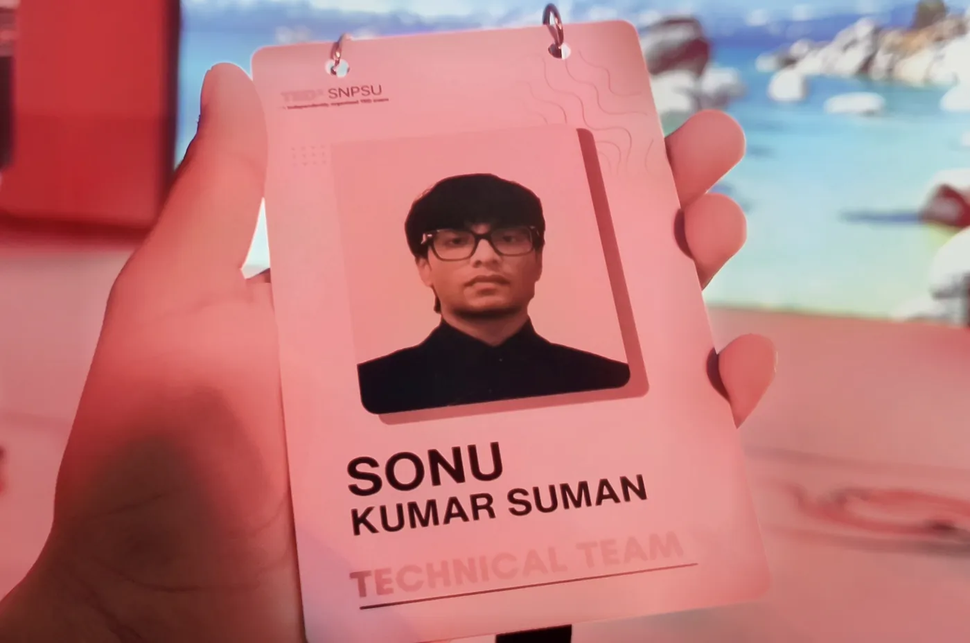 TEDxSNPSU technical team pass with the name Sonu Kumar Suman held up in front of the stage screen